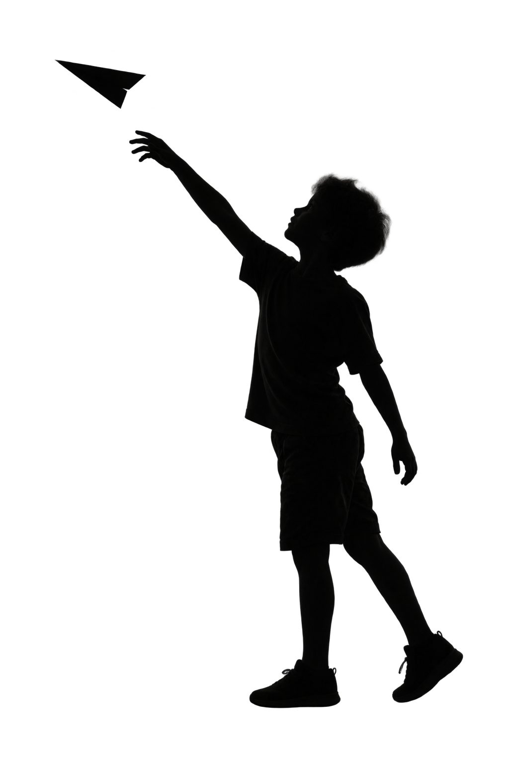 A child sending a paper plane into the air.